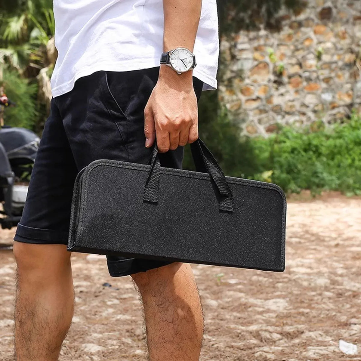 Homme tenant un étui noir pour Kit d'Outils de Barbecue en Acier Inoxydable Ustensile de chef en extérieur