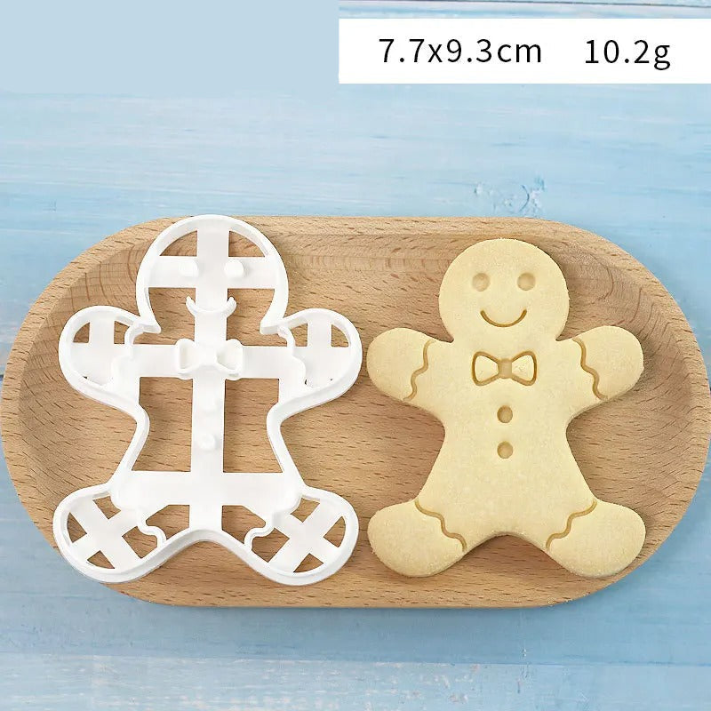 Emporte-Pièce Bonhomme en Pain d’Épices – 7 Modèles sur une planche en bois avec un biscuit en forme de bonhomme
