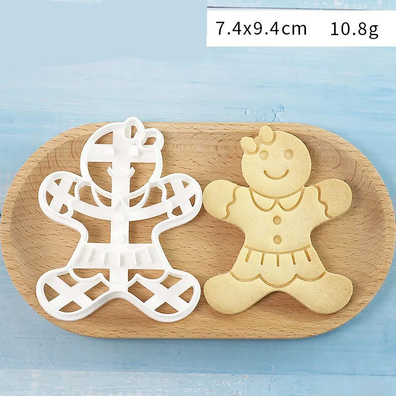 Emporte-Pièce Bonhomme en Pain d’Épices – 7 Modèles sur un plateau en bois avec un bonhomme en pain d'épices décoré