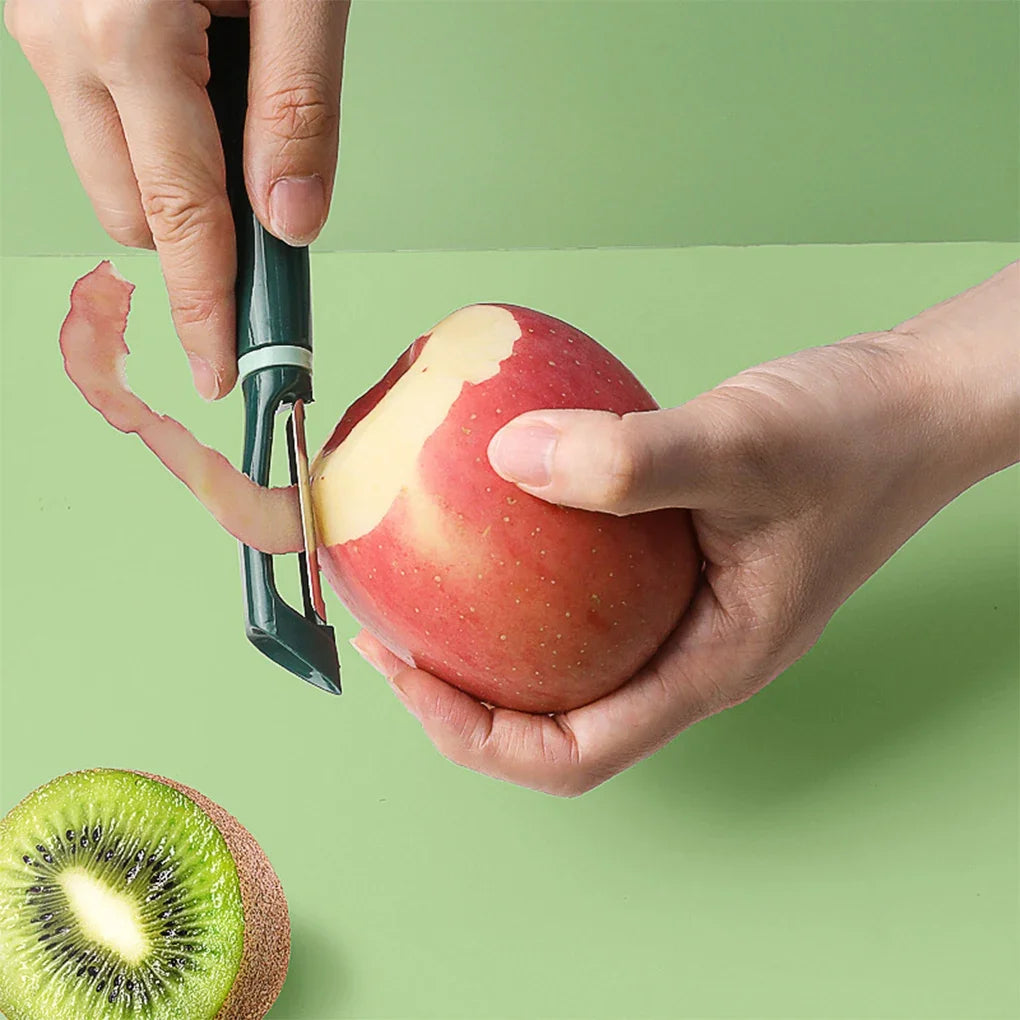 Éplucheur légume en Acier Inoxydable - Outil Ergonomique épluchant une pomme rouge avec un kiwi à côté