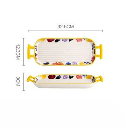 Plat de cuisson en céramique rectangulaire avec des poignées jaunes et motifs colorés