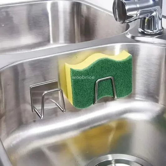 Support Éponge Auto-adhésif – Organisateur Cuisine support inox collé sur évier tenant une éponge jaune et verte